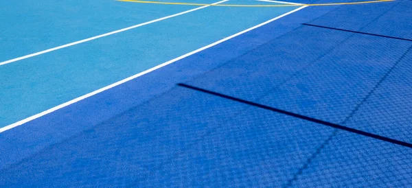 Colorful sports court background. Top view light blue and navy blue field rubber ground with white line outdoors
