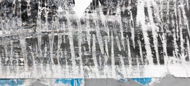 Old grunge torn collage urban street posters creased crumpled paper placard texture background. Ripped faded paper backdrop surface placard.