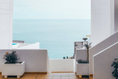 Architectural detail of white mediterranean house by the sea in sunny day. Minimal architecture building detail in Spanish coastline by Mediterranean sea in Spain.