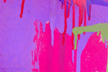 Messy paint strokes and smudges on an old painted wall background. Abstract wall surface with part of graffiti. Colorful drips, flows, streaks of paint and paint sprays. clipart