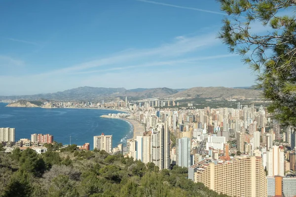 stock image Panorama of famous Benidorm resort city from Serra Gelada Natural Park. Coast of Mediterranean sea, Benidorm skyscrapers, hotels and mountains in the background. Alicante province, Spain.