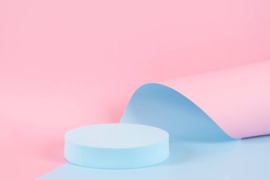 Abstract trendy composition with empty round podium platform for product or cosmetics presentation on pastel pink and light blue background. Trendy modern curved shaped lines. Front view.