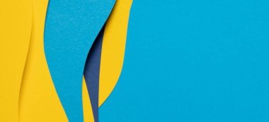 Abstract colored paper texture background. Minimal paper cut composition with layers of geometric shapes and lines in light blue, navy blue, yellow colors.