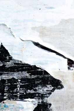 Old grunge torn collage urban street posters creased crumpled paper placard texture background. Ripped faded paper backdrop surface placard.