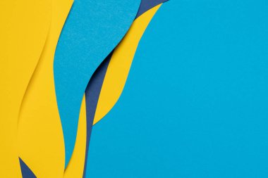Abstract colored paper texture background. Minimal paper cut composition with layers of geometric shapes and lines in light blue, navy blue, yellow colors.