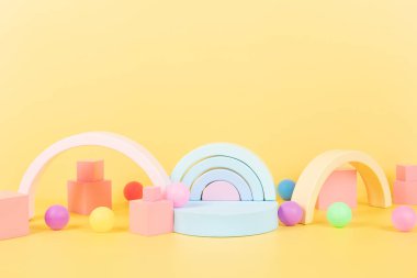 Oyuncak bebek geçmişi. Renkli, eğitici, doğal ahşap oyuncaklar, gökkuşağı, geometrik şekiller ve boş podyum, pastel sarı arka plan platformu. Ön görünüm.
