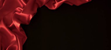 Soyut, zarif, lüks bir geçmişi var. Siyah ve kırmızı arka plan. Kumaşlı ve dalgalı ipek kumaş kıvrımları. Üst görünüm.