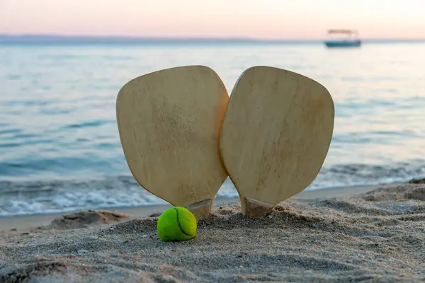 Beach tennis, beach paddle ball. Beach rackets and ball on the beach