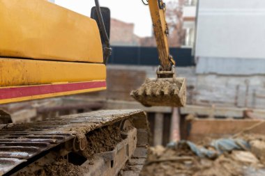 İnşaat kazıcısı inşaat alanında çalışıyor. Proje devam ediyor.