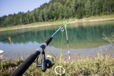 Resmedilmeye değer sahne, sakin gölde huzurlu bir balık avlanma gününü resmediyor. Huzurlu sular çevredeki doğal manzaranın güzelliğini yansıtıyor..