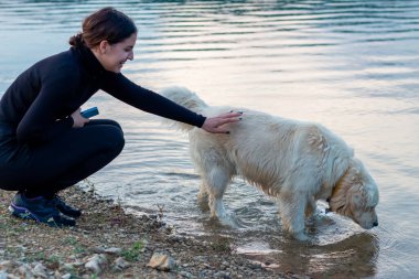 Nehir kıyısında köpekli bir kadın