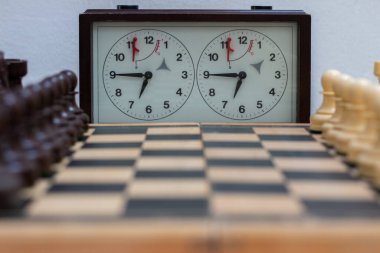 Chess board with chess game being played against white background. Opening game clipart