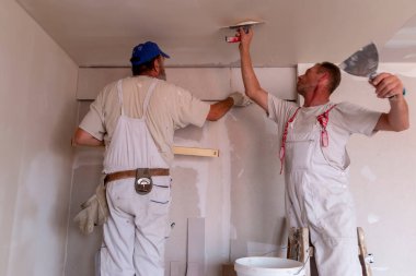 Apartman tamiri kavramı. Ev yenileme işçileri. Yenileme, yenileme, uzatma, restorasyon, yeniden yapılanma ve inşaat (modernizasyon) altında bulunan evde (bina) yeniden yapılanma ().