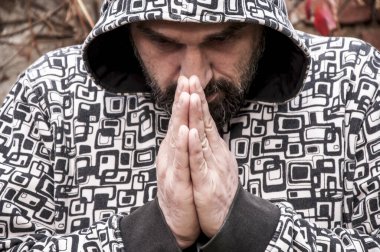 Hooligan  in a hoodie praying clipart