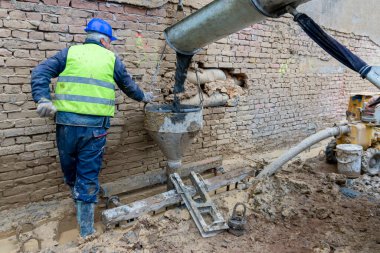 The concrete is unloaded from the concrete mixer into the foundations of the building. Construction of country houses. clipart