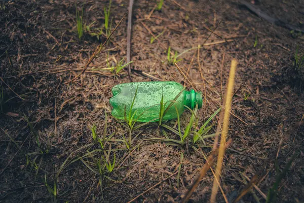 Green plastic bottle waste I found in nature