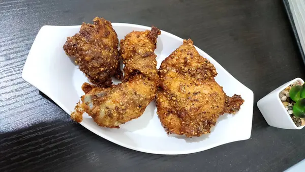coriander fried chicken on white plate