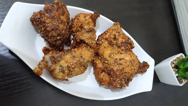 coriander fried chicken on white plate