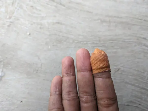 Human index finger covered in finger bandage