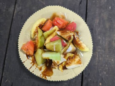 Rojak, Endonezya 'da sıkça bulunan bir meyve salatası türüdür ve üzeri sıvı kahverengi şekerle kaplıdır.