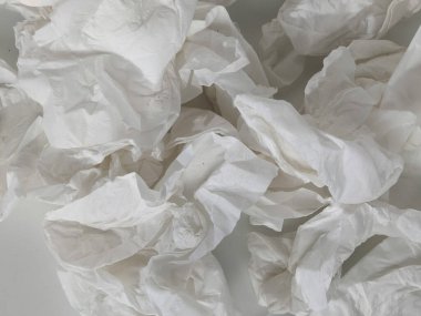 Kullanılmış dokular beyaz masaya saçılmış.