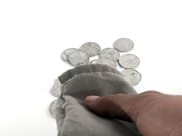 stock image 500 rupiah coins. Rupiah coins. taken out of a small bag. Stack of Indonesian Rupiah silver coins.