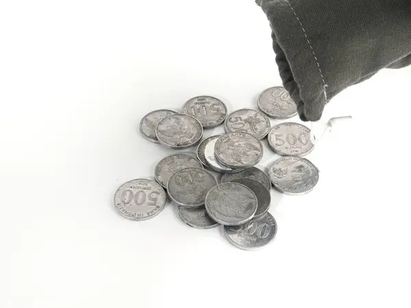 stock image 500 rupiah coins. Rupiah coins. taken out of a small bag. Stack of Indonesian Rupiah silver coins.