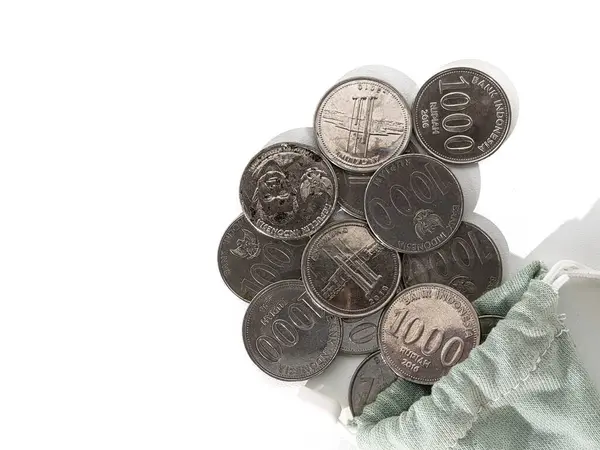 stock image 1000 rupiah coins. Rupiah coins. taken out of a small bag. Stack of Indonesian Rupiah silver coins.