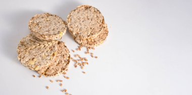 healthy diet light and crispy bread without yeast from whole grains on a white background, banner, space for text