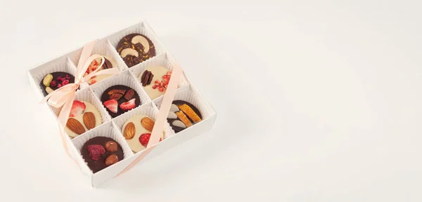 chocolate, homemade candies with candies and nuts in a gift box, on a white background, place for text