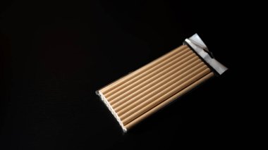 Natural wooden straws in biodegradable packaging ready for sustainable use in cafes and restaurants during eco-friendly events