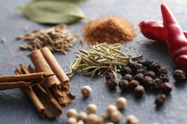 Mavi arka planda çeşitli baharatlar ve baharatlar fotoğraflandı.