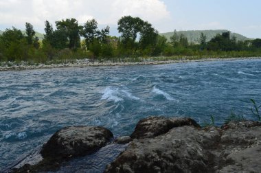 Yaz akşamı kayaların üzerinden akan dağ deresi.