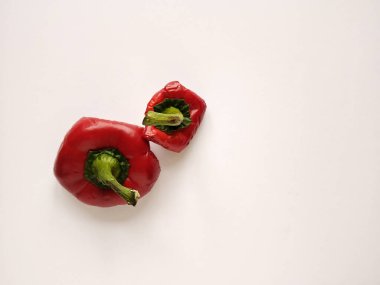 Red bell pepper cut in half. Pepper's parts with seeds. Light background with copy space. Garbage food. clipart