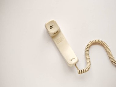 Eski model, durgun, parlak, siyah plastik bir telefon. Kablolu, izole edilmiş bir arka planı var. Metin için boşluk.