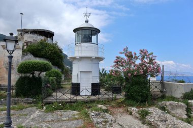 Scilla, Calabria, Italy  June 13, 2021: Navy lighthouse on a terrace of Castello Ruffo clipart