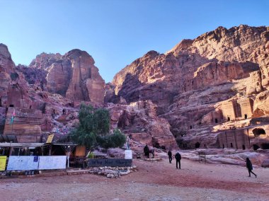 Petra, Jordan - January 7, 2023: Tourists along the Street of Facades in the 7th century BC Nabataean archaeological site, a Unesco heritage site