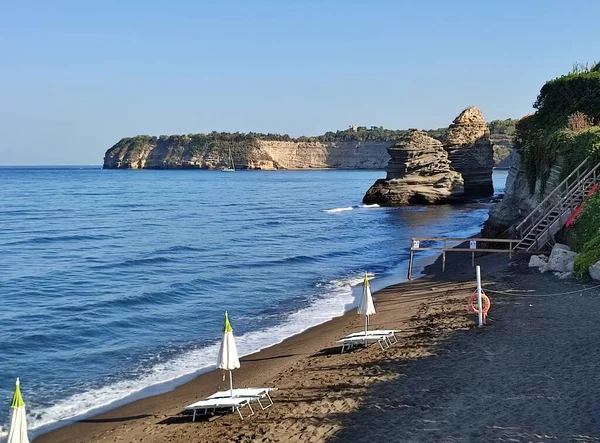 stock image Procida, Campania, Italy  October 1, 2021: Faraglioni of Procida along the Ciraccio beach on Lungomare Colombo