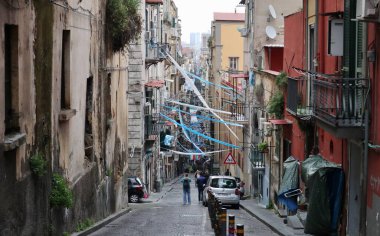 Naples, Campania, Italy - April 24, 2023: Glimpse of the alleys of the historic center festively decorated waiting for the conquest of the 3rd championship of the Napoli football team clipart