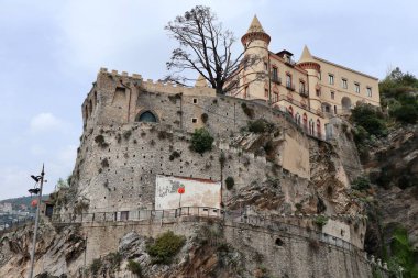 Maiori, Campania, Italy  April 16, 2024: Mezzacapo Castle, or Miramare Castle, built in the 19th century on the rock spur overlooking the port clipart