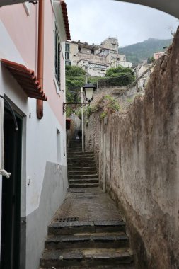 Maiori, Campania, Italy  16 April 2024: Panoramic view from Via Accola, a long staircase that goes up to the Castle of San Nicola de Thoroplano, built in the 9th century, which dominates the village of Maiori clipart