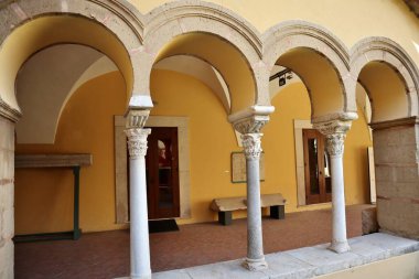 Benevento, Campania, Italy  March 25, 2023: 12th century Romanesque cloister annexed to the Lombard church of Santa Sofia, a UNESCO heritage site, which houses the archaeological section of the Museo del Sannio clipart