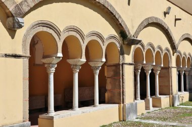 Benevento, Campania, Italy  March 25, 2023: 12th century Romanesque cloister annexed to the Lombard church of Santa Sofia, a UNESCO heritage site, which houses the archaeological section of the Museo del Sannio clipart