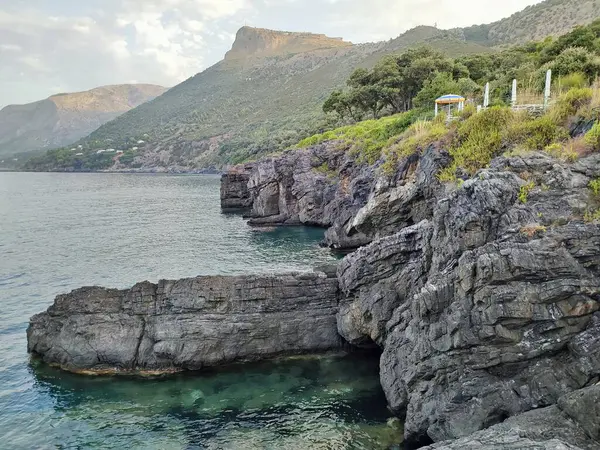 stock image Maratea, Basilicata, Italy - September 22, 2023: Cliff at Punta della Matrella from Le Terrazze Solarium at dawn