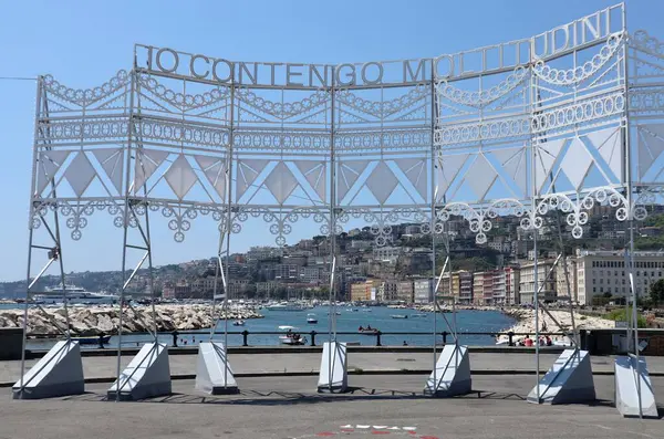 stock image Naples, Campania, Italy  August 6, 2024: Installation Io Contengo Moltitudini by artist Marinella Senatore in Rotonda Diaz on Lungomare Caracciolo. Two luminous sculptures, with writings, words and quotes, connected by dance steps drawn on the square