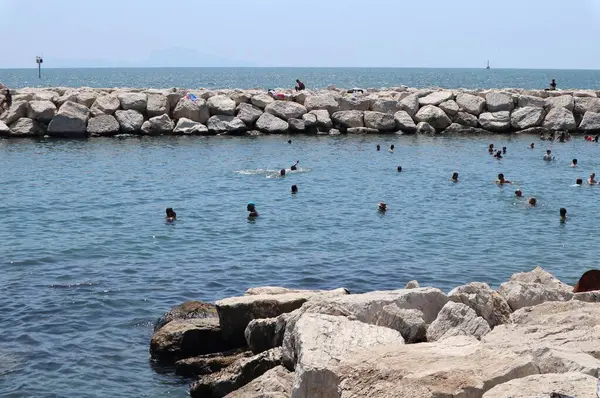 stock image Naples, Campania, Italy  August 6, 2024: Free beach of Lido Mappatella of Rotonda Diaz on Lungomare Caracciolo