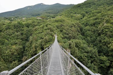 Laviano, Campania, Italy  June 24, 2023: Tibetan Bridge, opened to the public in 2015, which from the Rupe dellOlivella, near the Norman Castle, crosses the Vallone delle Conche at a height of about 90 meters from the ground clipart