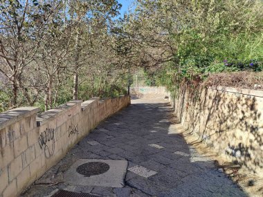 Naples, Campania, Italy  November 23, 2024: Access road to Cala San Basilio and the Marine Protected Area of the Gaiola Underwater Park from Via Tito Lucrezio Caro to Posillipo clipart