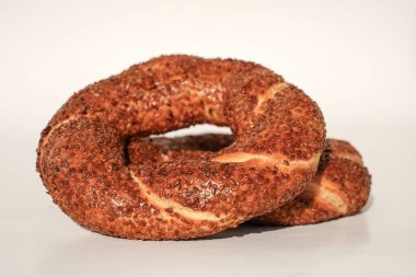 Beyaz arkaplanda susam tohumlu simit   