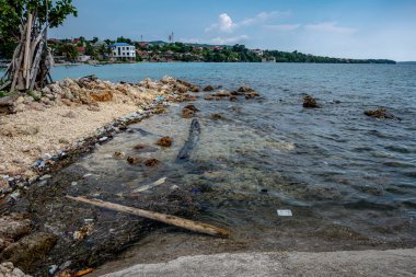 Pollution Crisis, A Scenic Coastal Town Struggles with Plastic Waste - Coastal Town Struggles with Pollution clipart